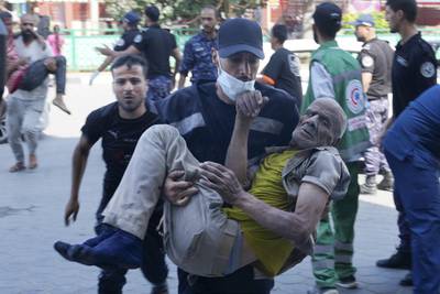 Palestinians wounded in Israeli air strikes are carried into Al Aqsa hospital in Deir El Balah, Gaza. AP Photo