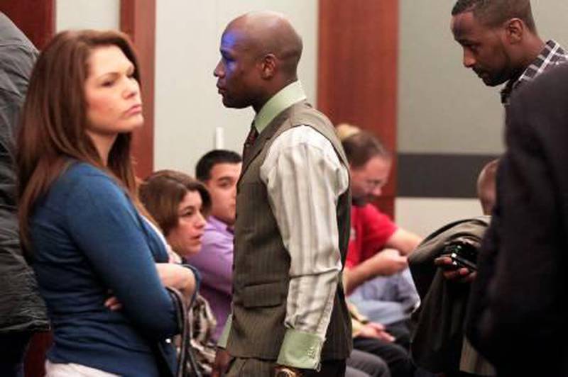 Boxer Floyd Mayweather Jr. (C) leaves court after pleading guilty to domestic violence and other charges at the Clark County Regional Justice Center in Las Vegas, Nevada December 21, 2011. Mayweather received a six-month sentence and will have to spend at least 90 days in jail. Mayweather must surrender to jail by January 6, 2012. REUTERS/Las Vegas Sun/Sam Morris (UNITED STATES - Tags: SPORT BOXING CRIME LAW) *** Local Caption ***  LAV05_USA-_1221_11.JPG