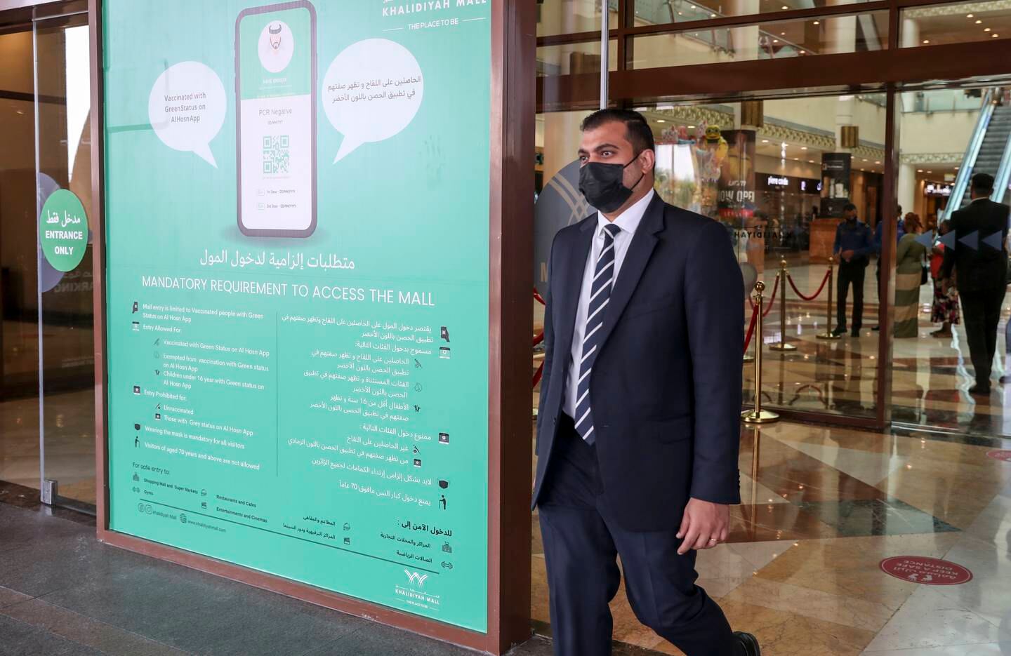 A sign outside Khalidiyah Mall in Abu Dhabi stipulating people must show proof of vaccination to enter. Khushnum Bhandari / The National 