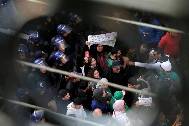 Algerian students are circled by a group a police officers during a protest in Algiers. AP Photo