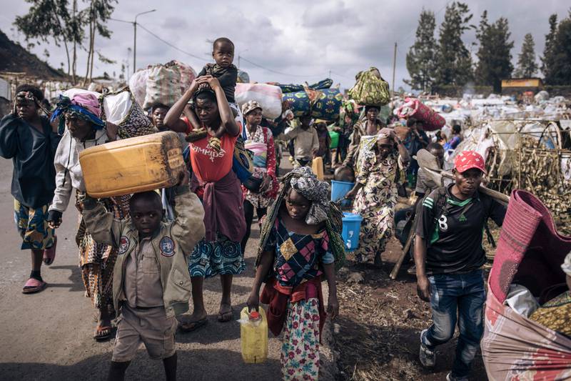 Displaced people flee towards the city of Goma, eastern Republic of Congo after soldiers retreated to Kanyarushinya, an informal camp of more than 40,000 people in the northern district of Goma. AFP