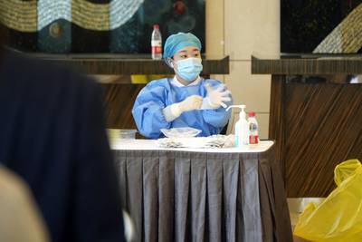 A health worker mans a Covid-19 testing booth at the media centre of the Belt and Road Forum in Beijing. Bloomberg