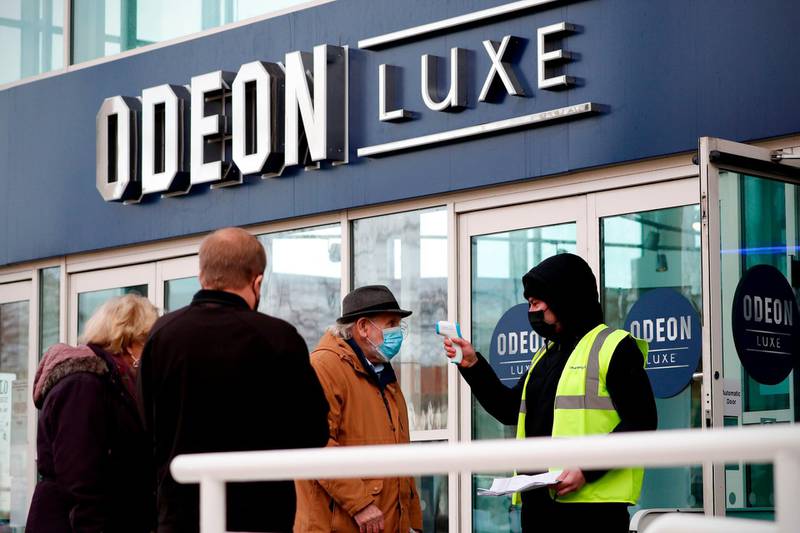 Members of the public arrive at a vaccination centre set up at an Odeon cinema complex in Aylesbury. AFP