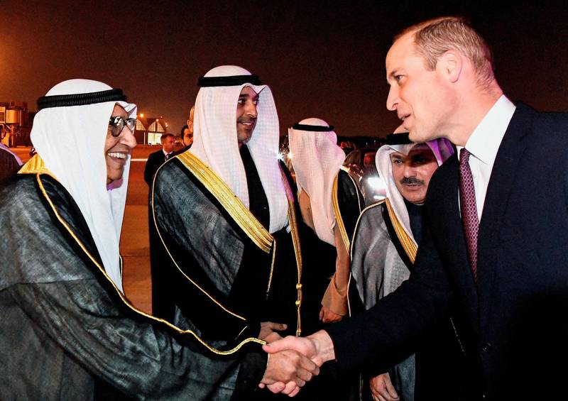 Prince William, the Duke of Cambridge, shakes hands with Kuwaiti officials upon his arrival at Kuwait International Airport. AFP