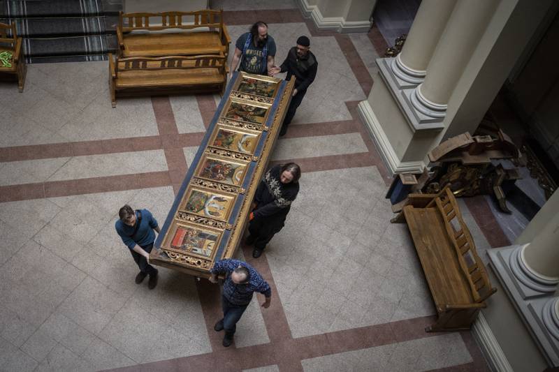 Workers move a piece of the Bohorodchany Iconostasis.
