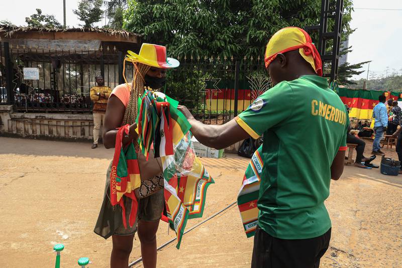 Theodore, 28, a vendor unwraps a scarf in Yaounde ahead of the Africa Cup of Nations in Cameroon.