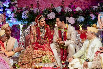 In this Saturday, March 9, 2019 photo, Akash Ambani, second right, son of Reliance Industries Chairman Mukesh Ambani and his wife Shloka Mehta smile as they perform a ritual at their wedding ceremony in Mumbai, India. (Reliance Industries Limited Photo via AP)