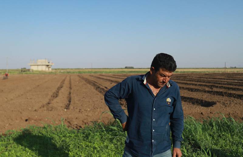 Syrian farmer Abdelbaqi Souleiman, 48, checks on his land near Qamishli. He lost his last wheat crop to a wildfire and had hoped for a better harvest this summer. But this spring there was hardly any rain.