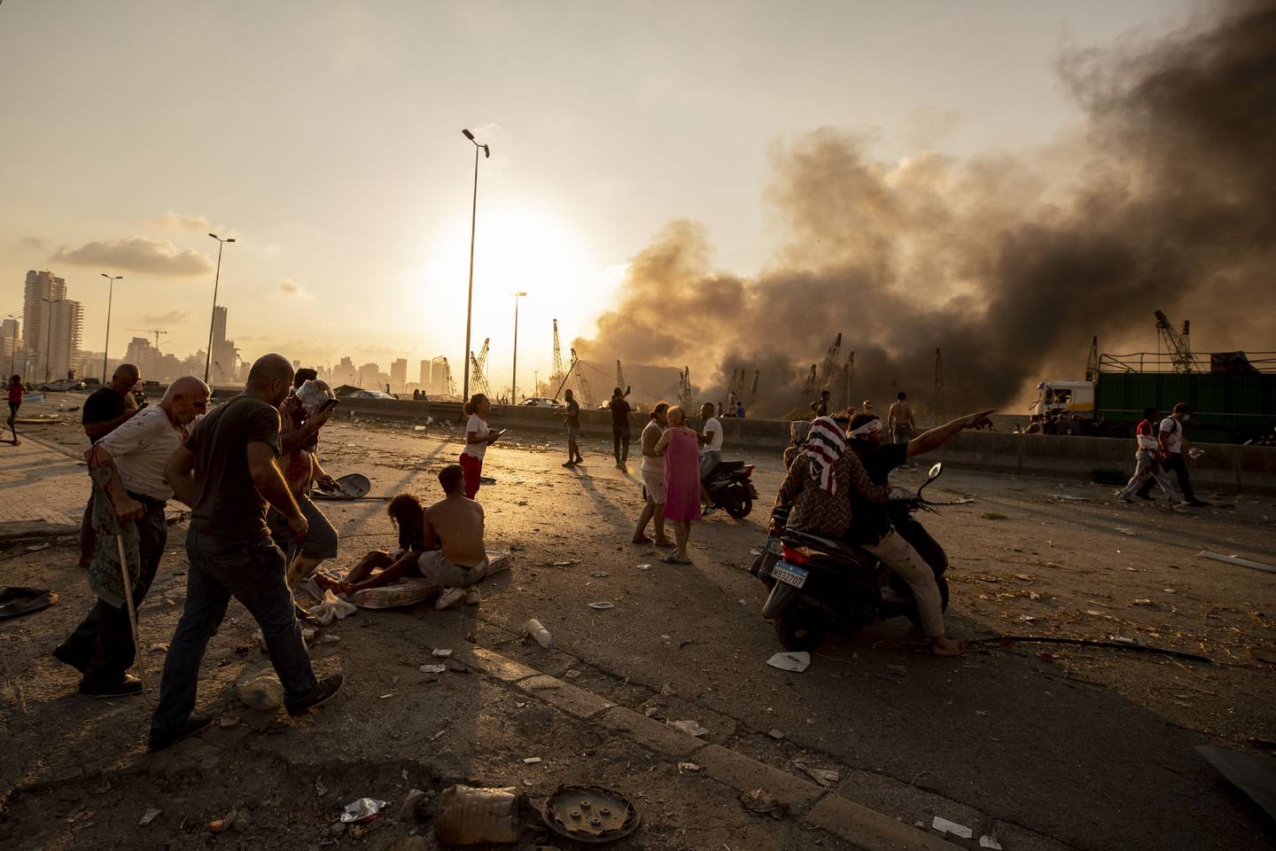 Wounded people are evacuated as smoke rises from the massive explosion in Beirut, August 4, 2020. AP 
