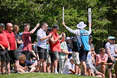 Golf fans watch play on the sixth hole. EPA