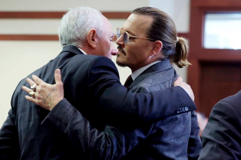 Actor Johnny Depp hugs business manager Edward White at the Fairfax County Circuit Court in Fairfax, Virginia. AP
