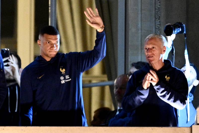 France forward Kylian Mbappe and manager Didier Deschamps greet supporters at the Hotel de Crillon in central Paris, on December 19, 2022, a day after their World Cup final defeat against Argentina in Qatar. AP