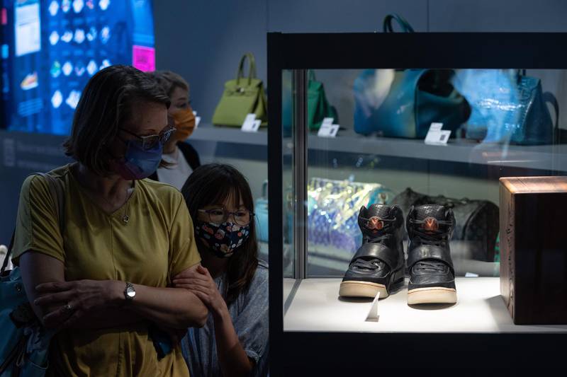 Visitors look at Kanye West 'Grammy Worn' Nike Air Yeezy 1 Prototype sneakers, right, on display during a Sotheby's auction preview in Hong Kong. EPA