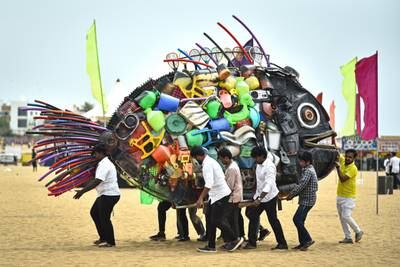 Volunteers carry an installation depicting a fish made from plastic waste to raise awareness at Edward Elliot's beach, in Chennai, India. EPA
