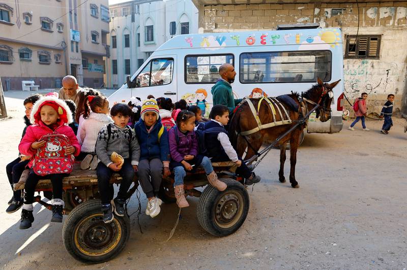 A Palestinian man offers children in kindergarten a cheap ride on his donkey-drawn cart in Gaza. Reuters