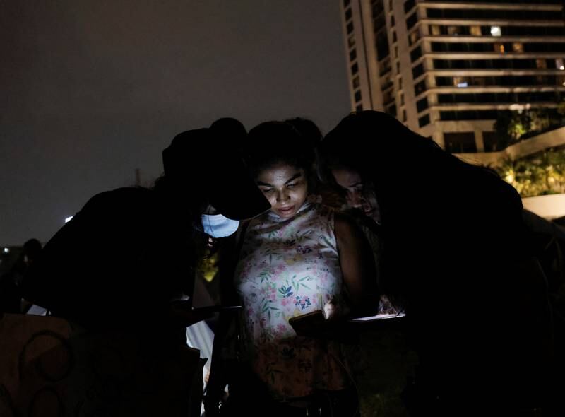 Residents of Gota-Go Village in Colombo use their phones to organise their protest against President Gotabaya Rajapaksa's management of the economy. Reuters