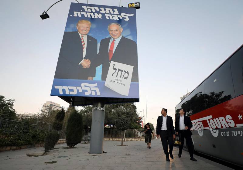 Ultra-Orthodox Jewish men walk past a Likud party election campaign banner depicting Israeli Prime Minister Benjamin Netanyahu and U.S. President Donald Trump in Jerusalem September 11, 2019. REUTERS/Ammar Awad
