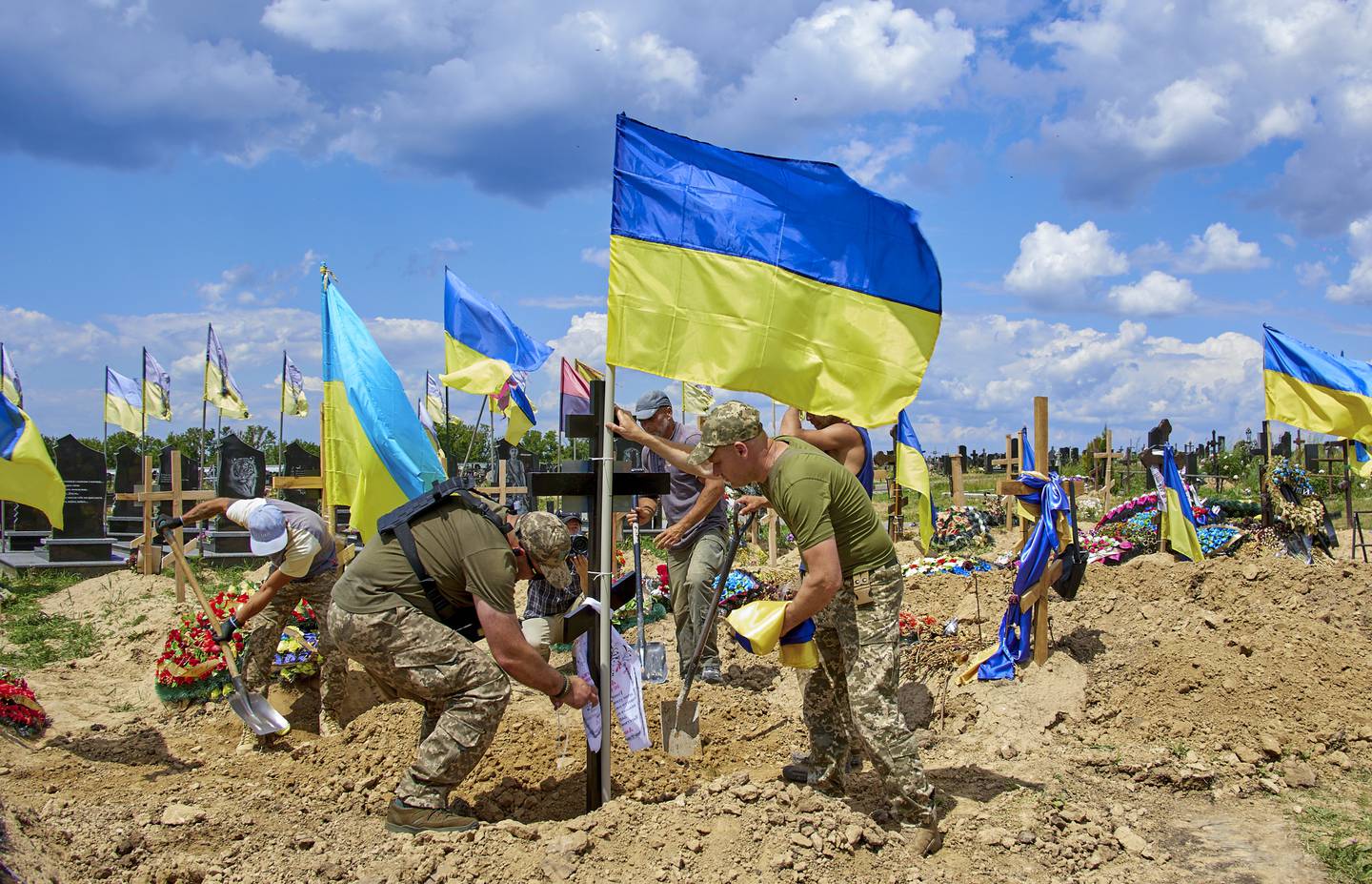 A Ukrainian flag is placed on the grave of military medic Yevhen Khrapko, who was killed during the evacuation of wounded servicemen from a fighting zone. He was buried at a cemetery in the eastern Ukrainian city of Kharkiv. EPA 