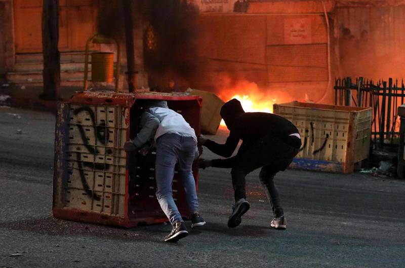Palestinians throw stones during clashes with Israeli security forces in the wake of a protest against US President Donald J. Trump's Middle East peace plan to solve the conflict between Palestinians and Israel, near the West Bank City of Hebron.  EPA