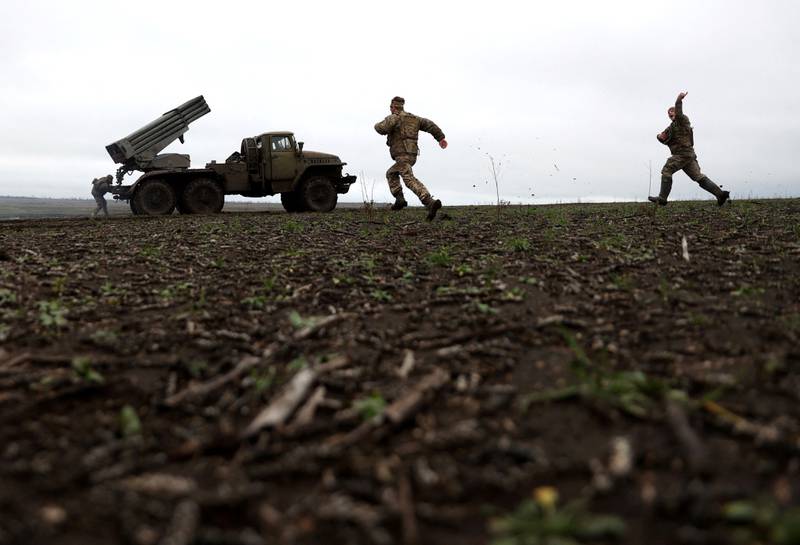 Ukrainian servicemen rush to change their BM-21 Grad's position after firing towards Russian positions on the front line near Bakhmut, eastern Ukraine. AFP
