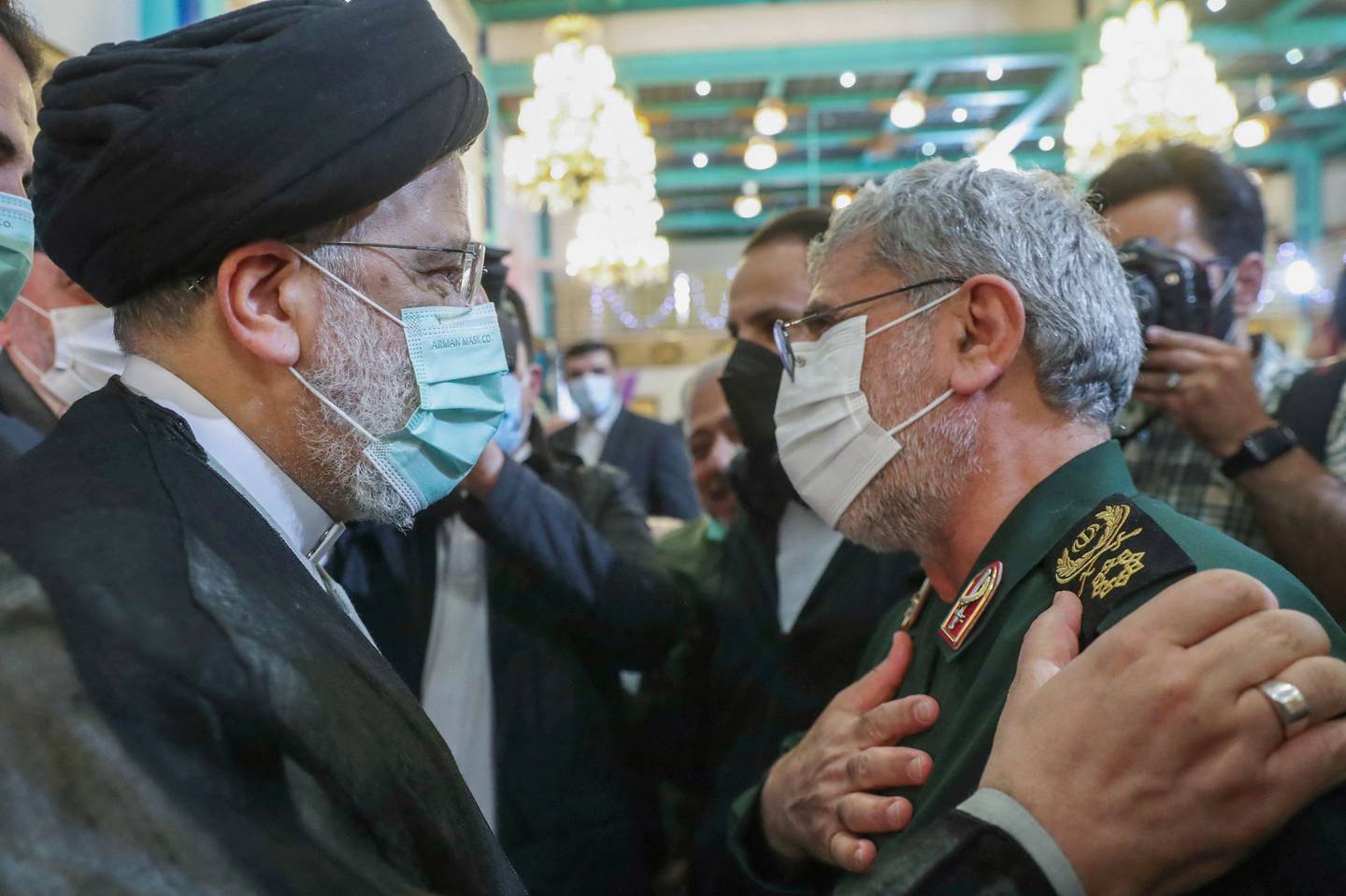 Iranian President Ebrahim Raisi, left, greets Esmail Qaani of the Quds Force in Tehran in March. AFP