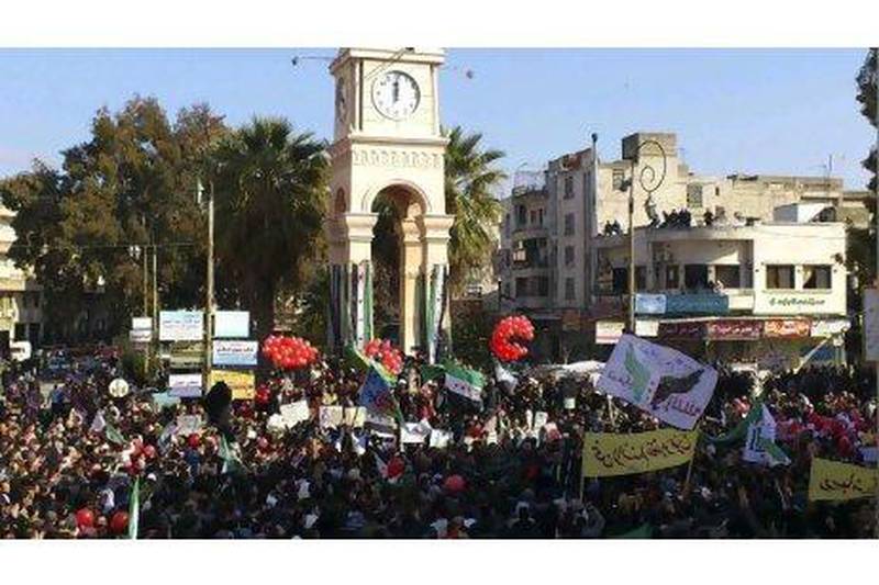 Demonstrators protest against Syria's President Bashar Al Assad after Friday prayers in Idlib.