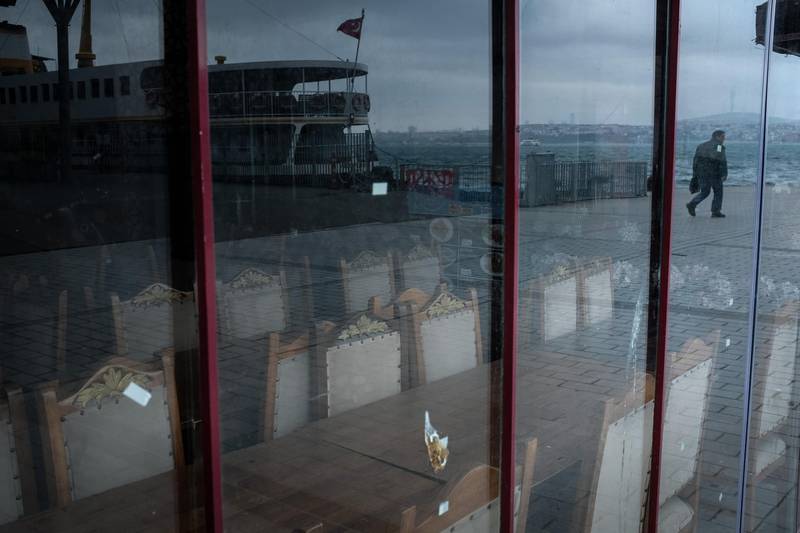 Empty chairs and tables are seen in a closed shop as a man walks towards a near-empty ferry pier in Istanbul, Turkey. Turkey has confirmed 168 deaths and 11,535 positive cases of the coronavirus, officials continue to implement steps to contain the spread of the virus including a ban on all intercity bus travel, all Internationals flights have been stopped and recreational activities such as fishing, jogging and barbecuing have been suspended in a bid to stop the spread of the virus. Getty Images