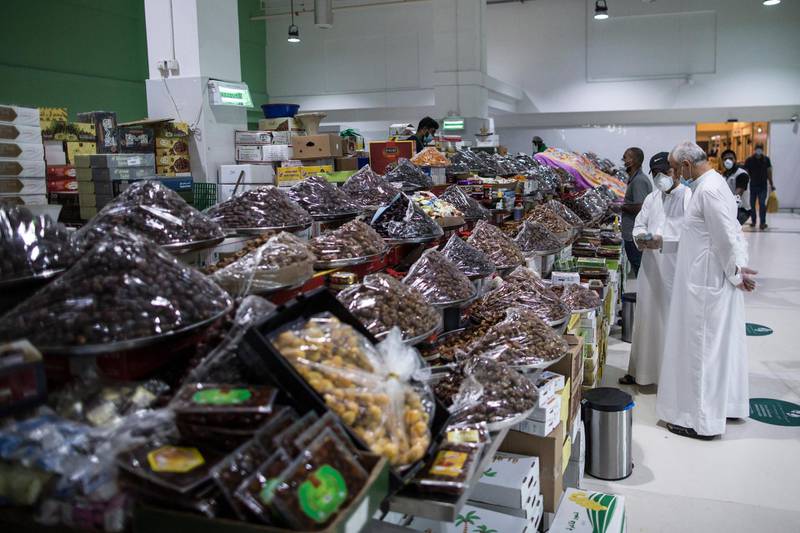 Customers wearing protective masks as they shop at the vegetables market for the upcoming Ramadan in Dubai. EPA