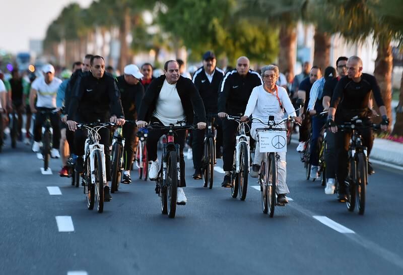 Mr El Sisi, second left, takes part in a cycling marathon on the sidelines of Cop27. EPA