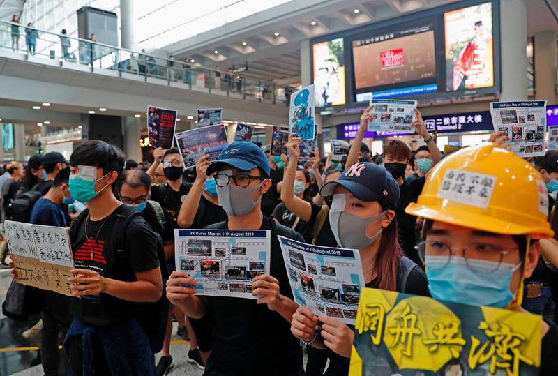 Anti-extradition bill protesters cover their eyes with gauze during a mass demonstration after a woman was shot in the eye during a protest at Hong Kong International Airport, in Hong Kong, China.  Reuters