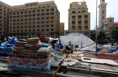 People dismantle tents after Lebanese security forces cleared away a protest camp and reopened roads blocked by demonstrators since protests against the governing elite started in October, in Beirut. REUTERS