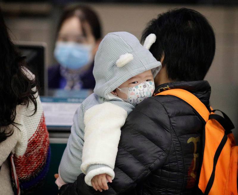 A child wears a mask at Guangzhou airport in Guangzhou. EPA