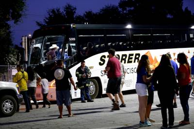 Festival attendees are whisked away from the scene on buses.  AP