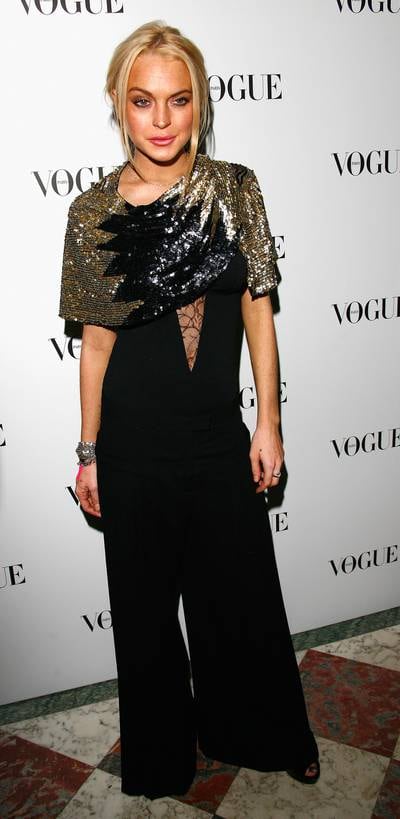 Lindsay Lohan, in a sequinned scarf and black catsuit, attends the 90 years of Vogue covers party in Paris, France on October 1, 2009. Getty Images