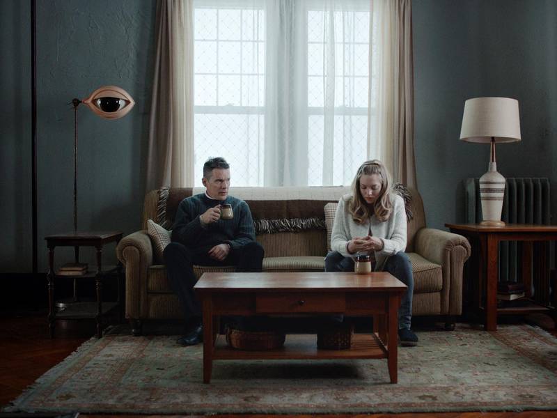 This image released by A24 shows Ethan Hawke, left, and Amanda Seyfriend in a scene from "First Reformed." (A24 via AP)