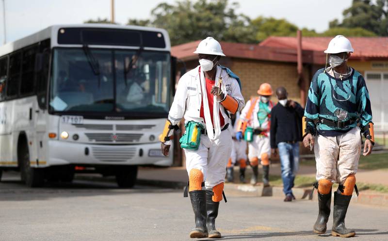 FILE PHOTO: Mine workers wearing face masks arrive ahead of their shift at a mine of Sibanye-Stillwater in Carletonville, South Africa, May 19, 2020. REUTERS/Siphiwe Sibeko/File Photo