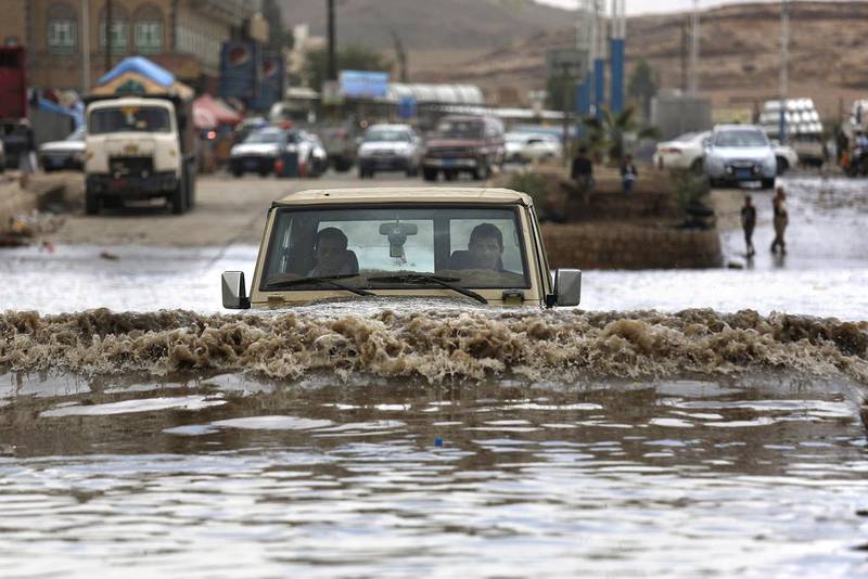 A motorist drives in floodwaters after a heavy rain in Sanaa, Yemen on April 13, 2016. Hani Mohammed/ AP Photo