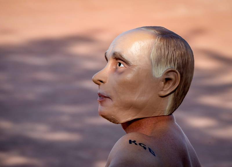 A man wearing a Vladimir Putin mask takes part in a demonstration in Geneva. AP Photo