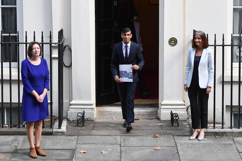 Britain's Chancellor of the Exchequer Rishi Sunak (C) holds his Winter Econmy Plan as he poses with Carolyn Fairbairn, Director General of the Confederation of British Industry (CBI)(R)and Frances O'Grady, General Secretary of the Trades Union Congress (TUC) outside 11 Downing street in central London on September 24, 2020.  Finance Minister Rishi Sunak will unveil his "Winter Economy Plan" before parliament today, amid mounting fear that the end of his furlough jobs retention scheme next month could spark mass unemployment.
 / AFP / JUSTIN TALLIS
