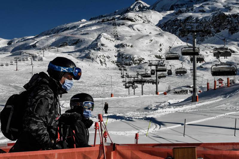 People take a ski lift wearing a mandatory mask as a preventive measure against Covid-19, in the Alpe d’Huez ski resort, France. AFP