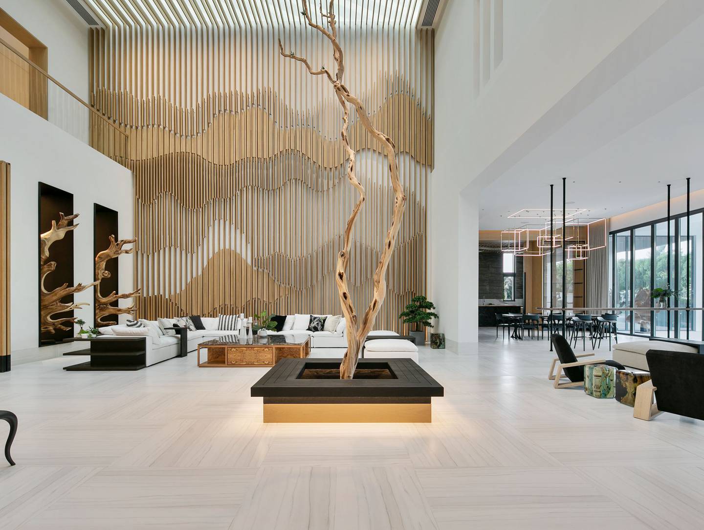 A timber Tree of Life=inspired sculpture in the double-height central hub of the property. 
