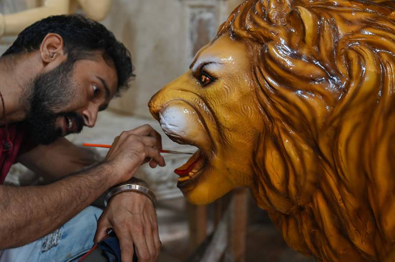 An artisan works on a lion sculpture. The lion in Hindu mythology is the ride for goddess Durga. AFP