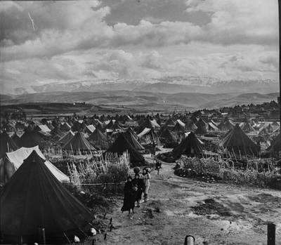 In this photo taken in 1952, refugees walk through Nahr el-Bared, a refugee camp in Lebanon which was one of the first camps established as part of emergency measures to shelter Palestine refugees of the Arab-Israeli conflict in 1948. S Madver/AP Photo/ UNRWA Photo Archives