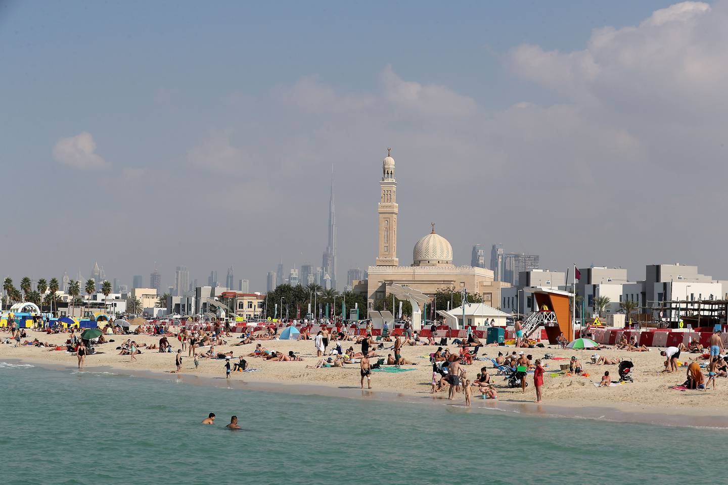 People enjoying the Sunday holiday with their family members at the Kite beach in Dubai. Pawan Singh / The National