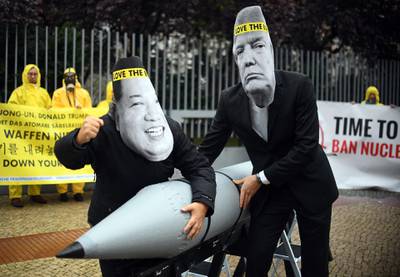 (FILES) In this file photo taken on September 13, 2017 activists of the International campaign to abolish Nuclear Weapons (ICAN) wearing masks of US President Donald Trump (R) and North Korea's leader Kim Jong-un as they demonstrate in front of the US embassy in Berlin. Left-leaning allies of Chancellor Angela Merkel's ruling conservatives launched an offensive on May 3, 2020 calling for the withdrawal of US nuclear arms in Germany. - Germany OUT
 / AFP / dpa / Britta Pedersen
