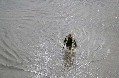Municipal worker walks in a flooded street during a thunderstorm and heavy rains in Cairo. Reuters