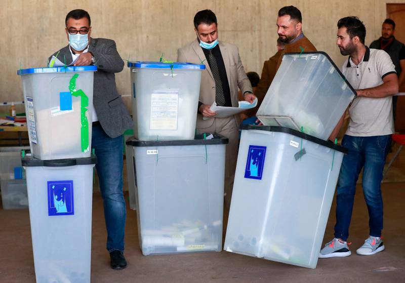 Employees of Iraq's Independent High Electoral Commission conduct a partial manual recount of votes for the October 10 elections, in Baghdad on November 23.  AFP