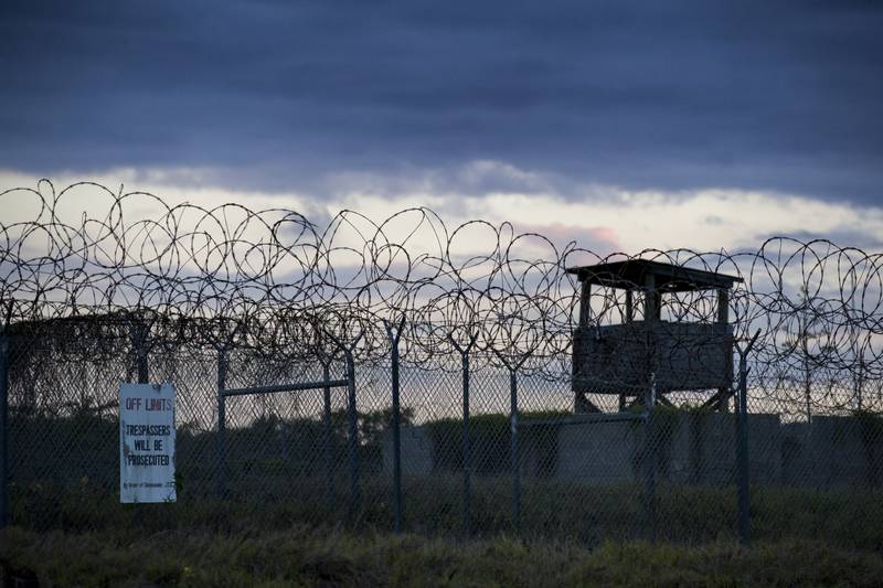 The sun sets behind the closed Camp X-Ray detention centre at Guantanamo Bay Naval Base, Cuba, in 2019. AP