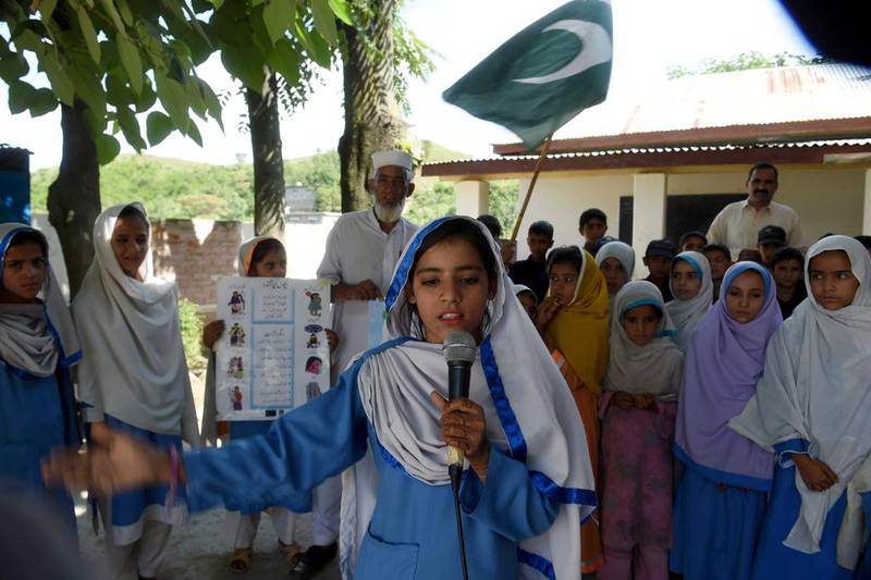 Hindko speaking schoolchildren sing the national anthem at their school in Mansehra., Pakistan on August 30,2016 Farooo Naeem / AFP

 