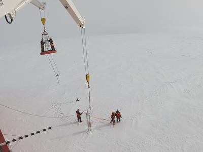 Researchers from NYUAD's Centre for Global Sea Level Change on their way to retrieve a mast installed on sea ice in the Southern Ocean in 2019.